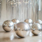 Metallic silver 39" sphere balloons for party decorations.