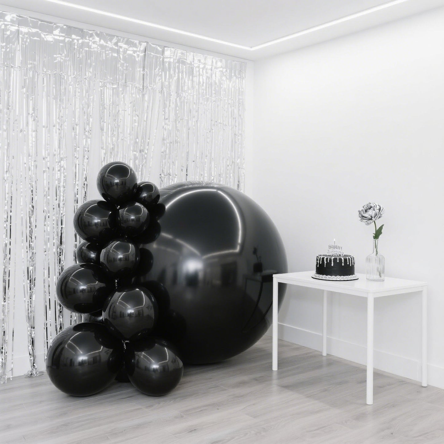 Metallic black sphere balloons for party decorations.