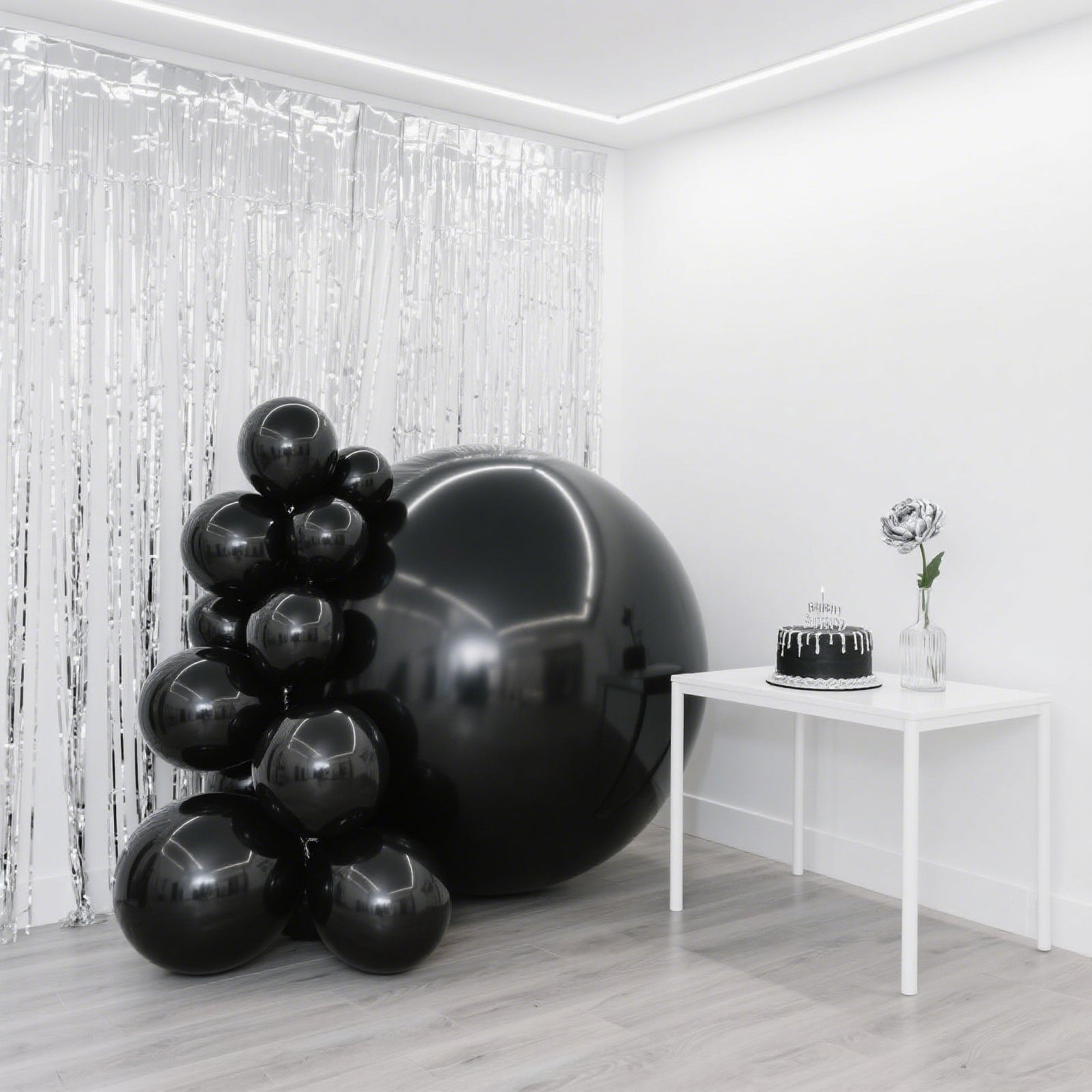 Metallic black sphere balloons for party decorations.