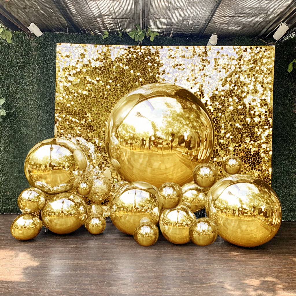 Metallic gold sphere balloons on a festive backdrop for party decorations.