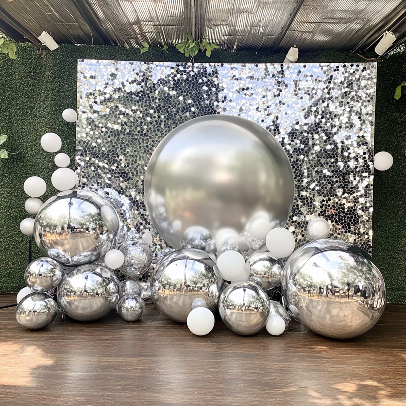 Metallic silver sphere balloons, party decorations for celebrations.