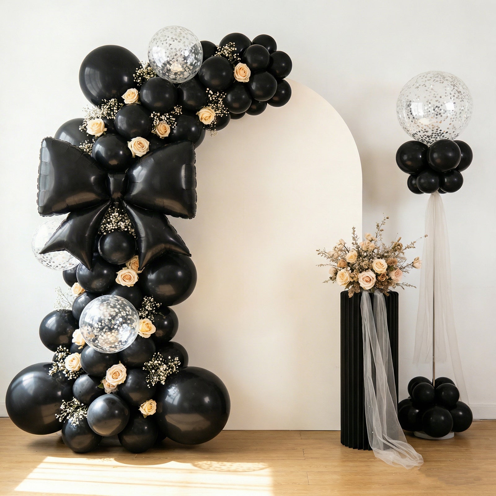 Matte black giant foil bow balloons in a stylish party backdrop.