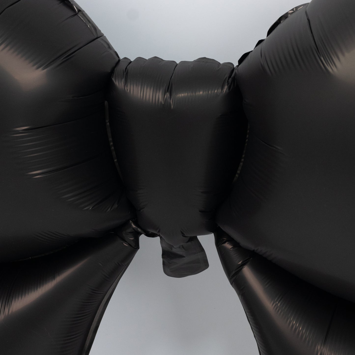 Matte black giant decorative foil bow balloons for event styling.