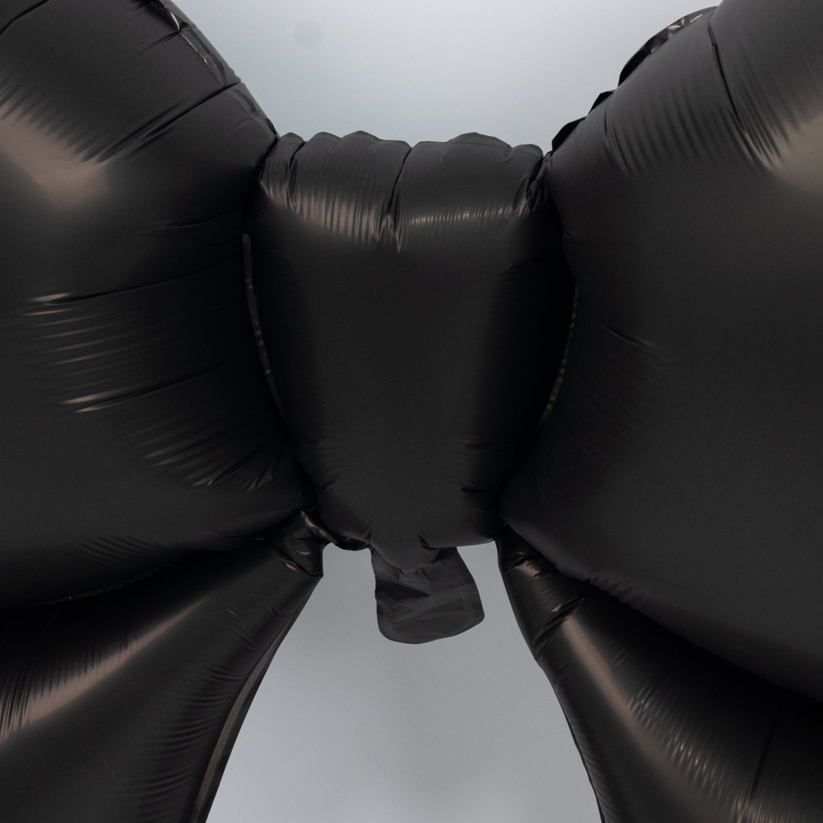 Matte black giant decorative foil bow balloons for event styling.