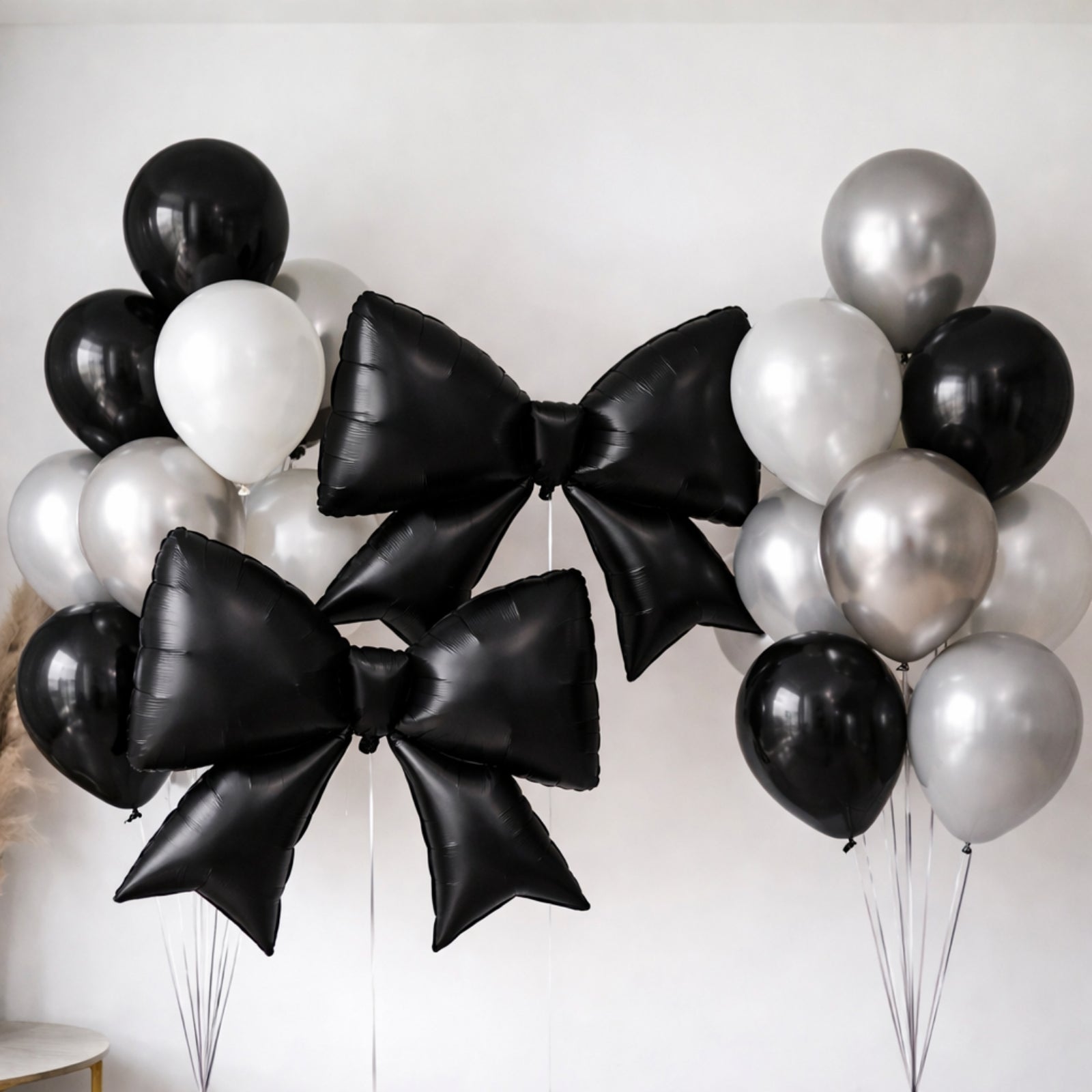 Matte black giant decorative foil bow balloons for event styling.