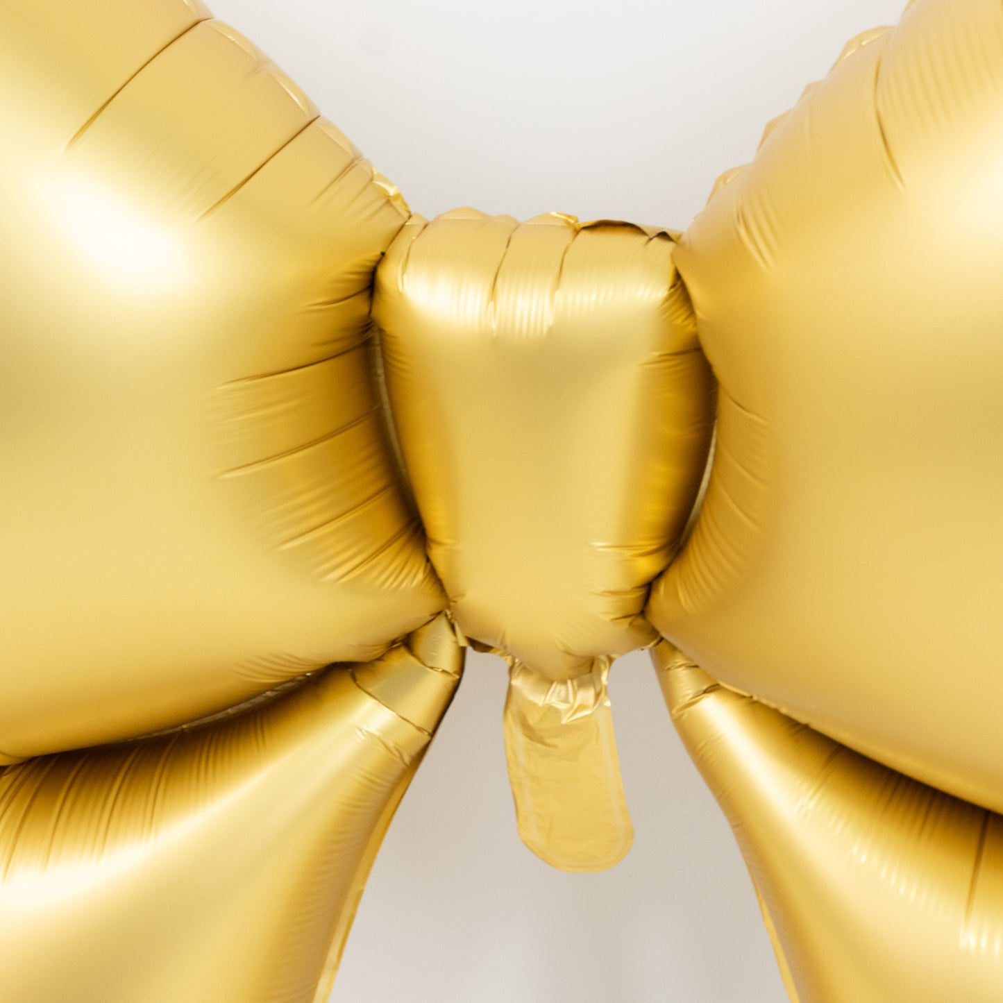 Matte gold giant decorative foil bow balloon, perfect for events and backdrops.