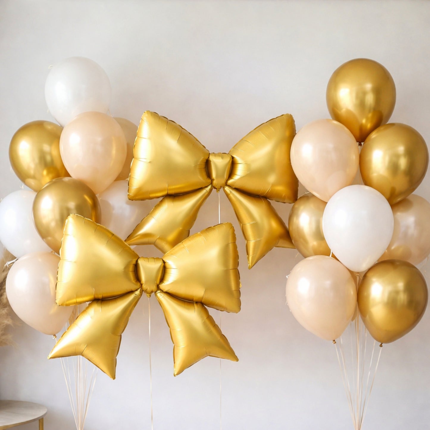 Matte gold decorative bow balloons for party backdrop and photo booth.