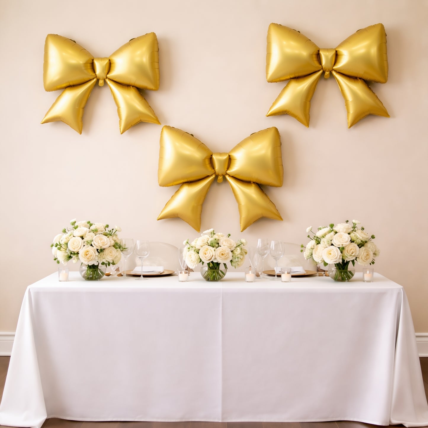 Matte gold giant decorative foil bow balloons for party backdrop and event styling.