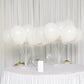 Clear balloon centerpieces holder kit with white balloons on a table.