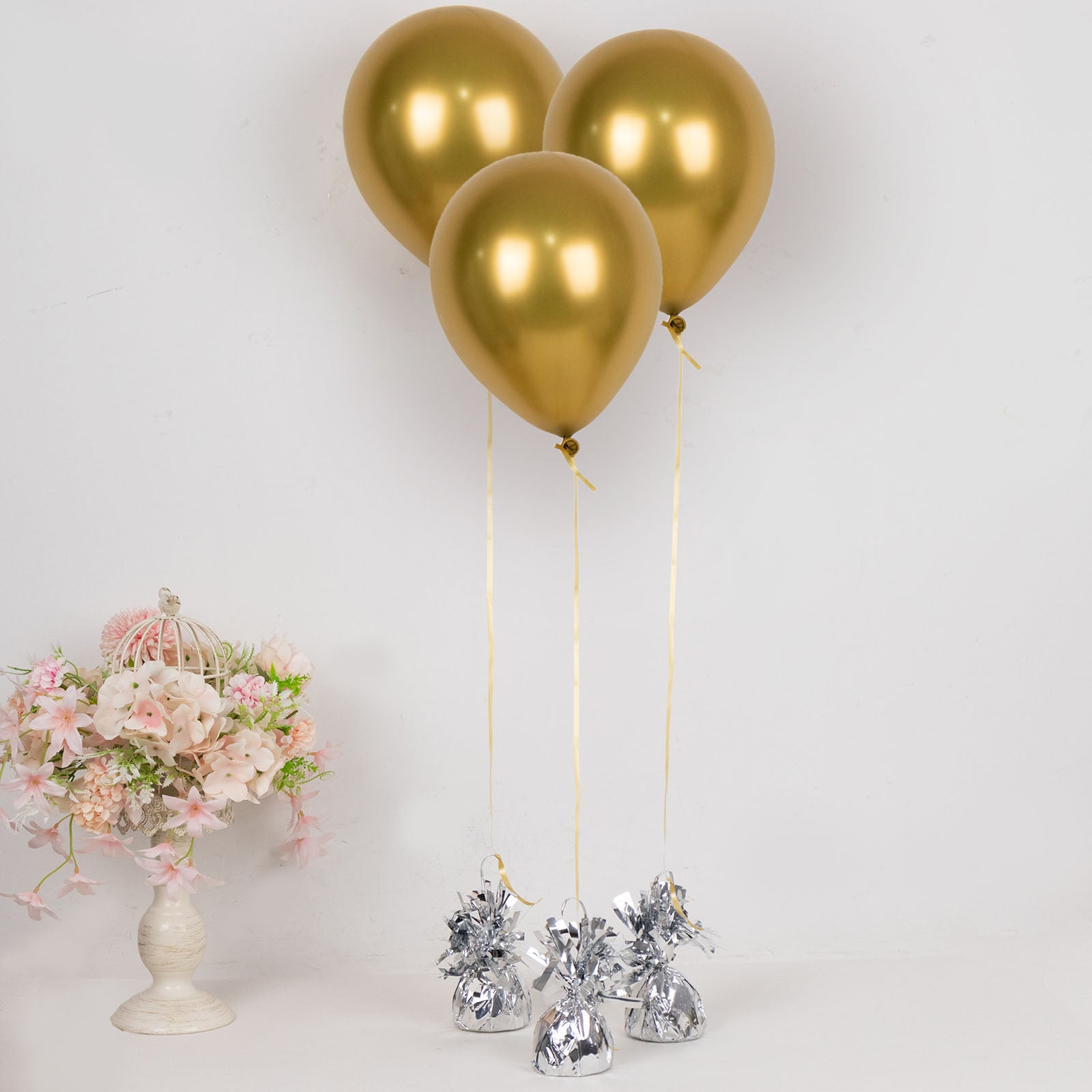Metallic silver foil tassel balloon weights with gold balloons.