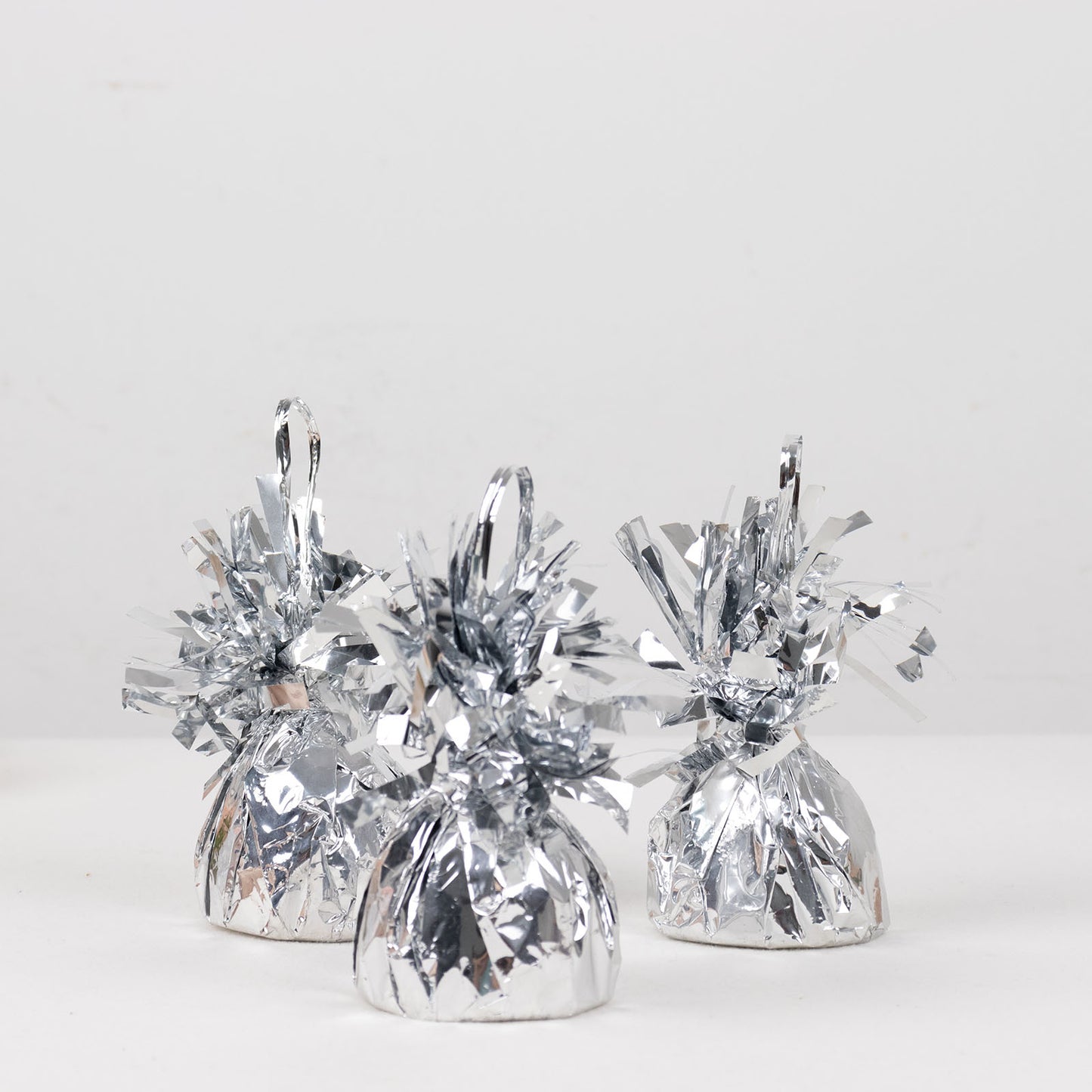 Metallic silver foil tassel top balloon weights, set of 12.