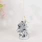 Metallic silver foil tassel top party balloon weight with yellow ribbon.