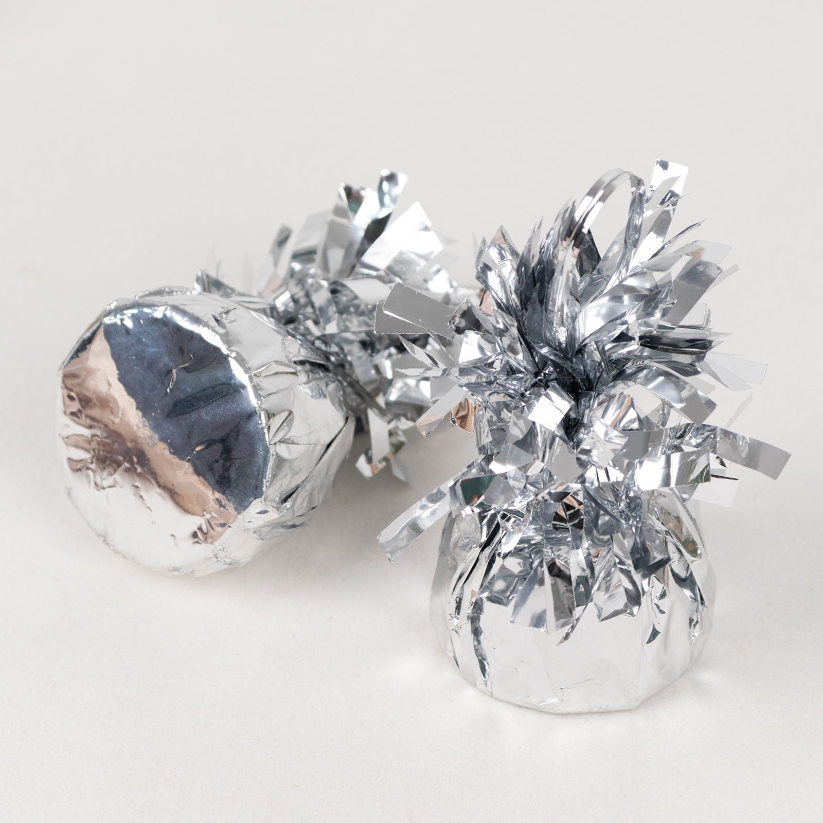 Metallic silver foil tassel top party balloon weights, 5.5oz, 12 pack.