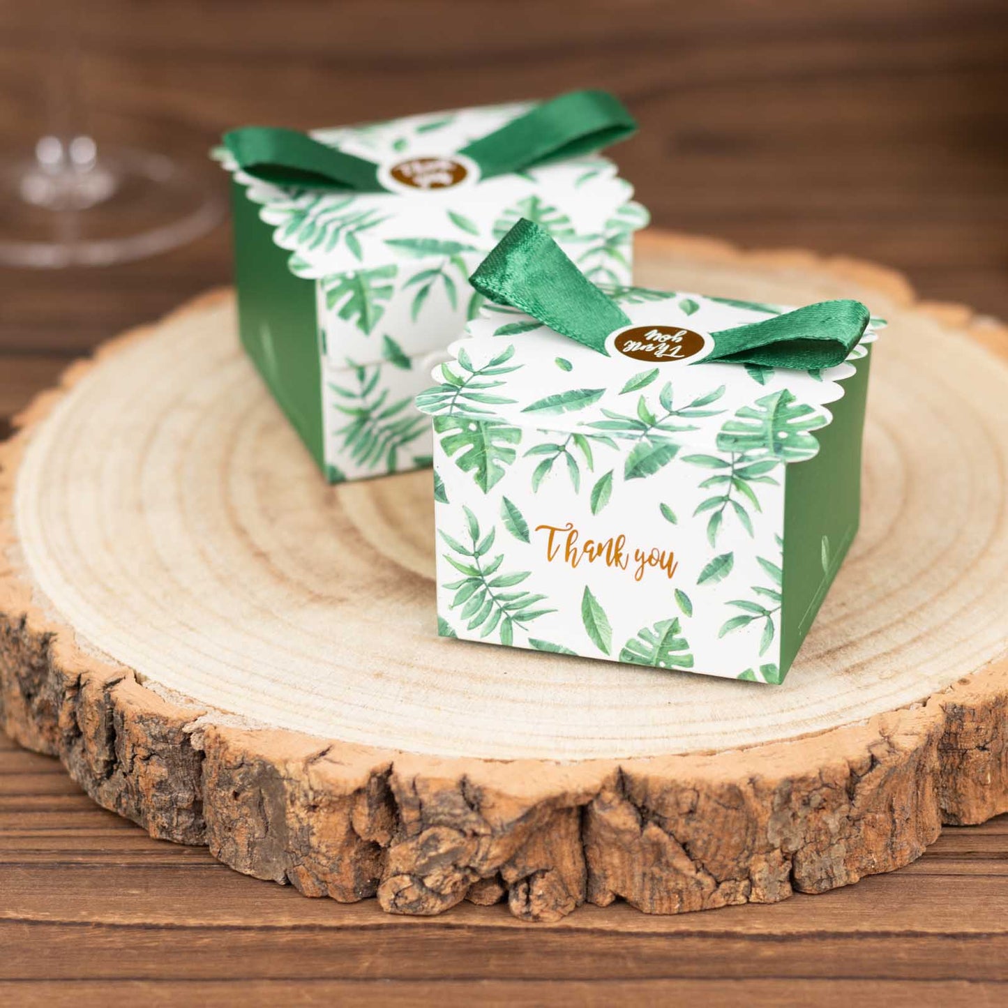 Green monstera leaf print candy gift boxes with satin ribbon bow.