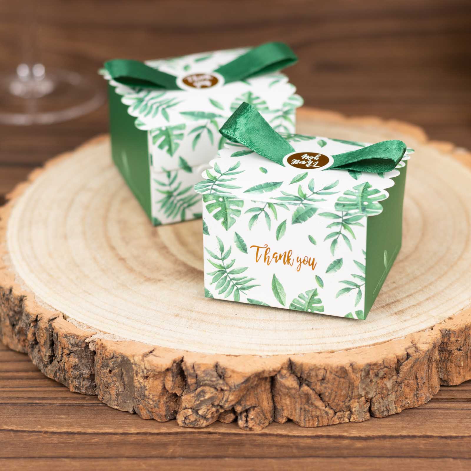 Green monstera leaf print candy gift boxes with satin ribbon bow.