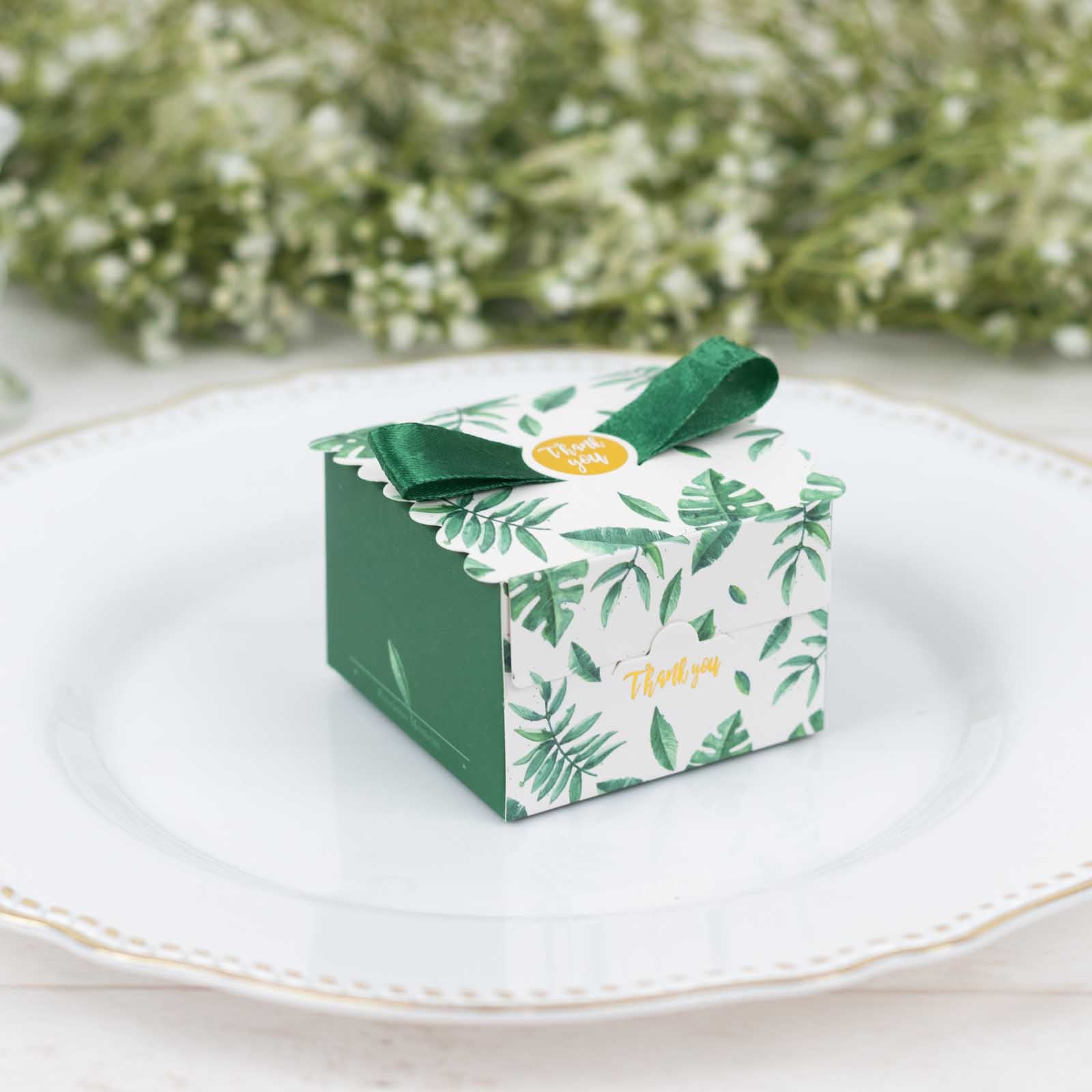 Green monstera leaf print candy gift box with satin ribbon bow.