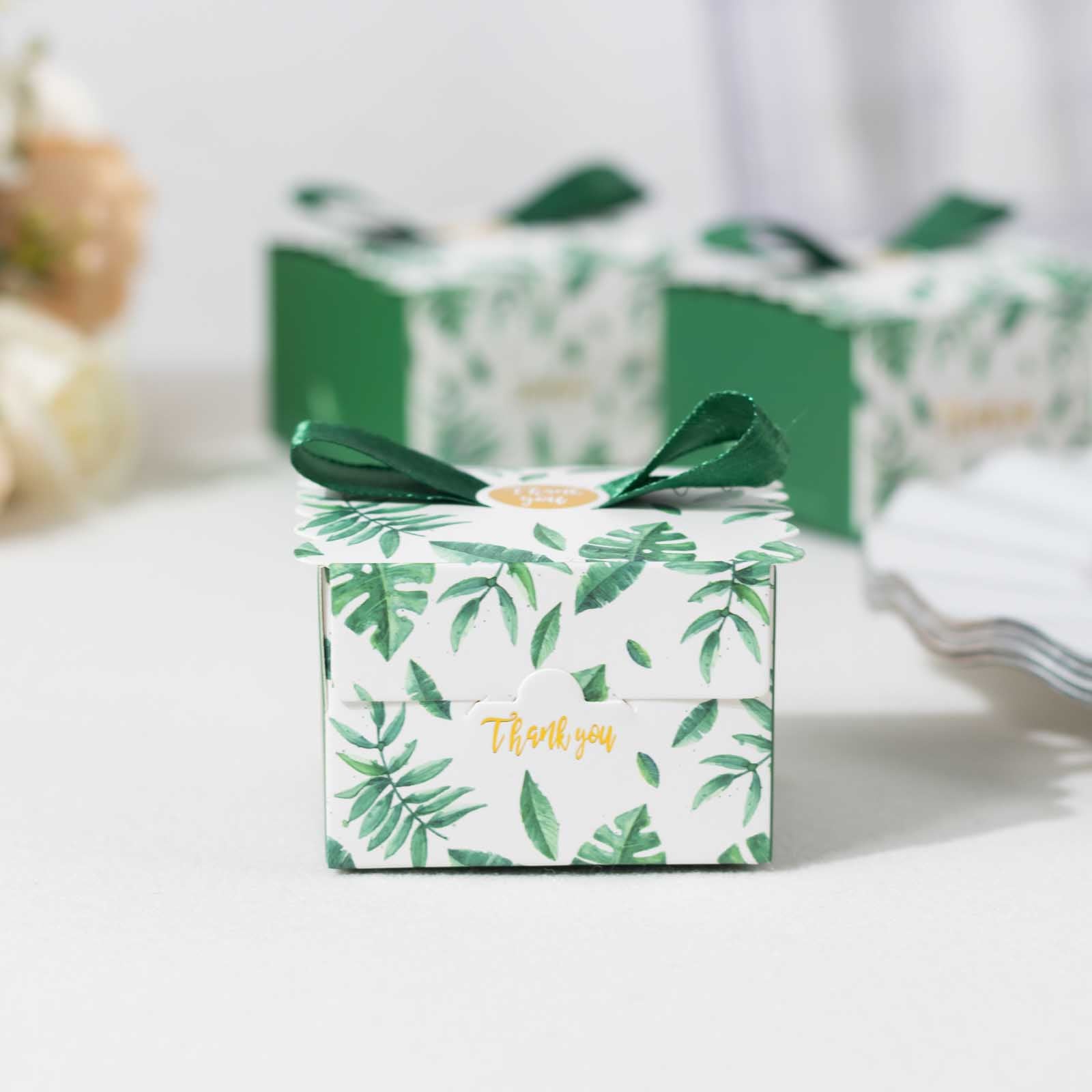 Green Monstera leaf candy gift box with satin ribbon bow.