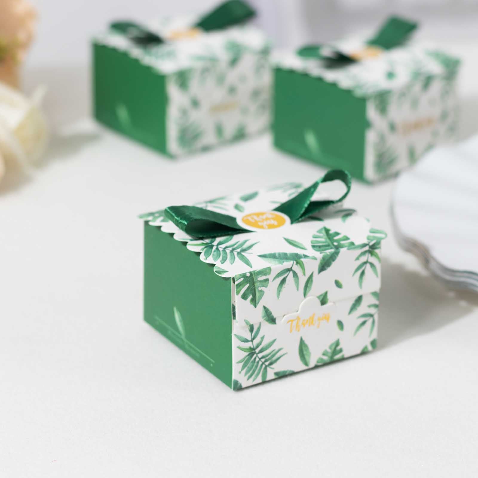 Green monstera leaf print candy gift box with satin ribbon bow.