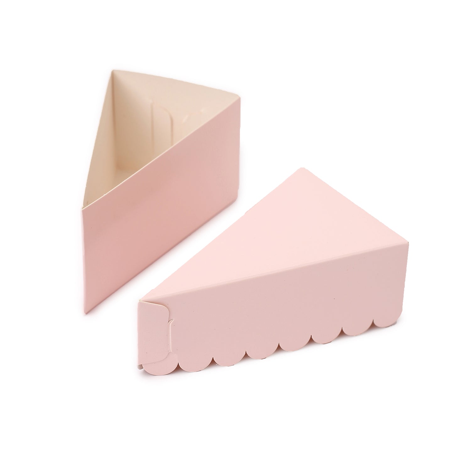 Blush triangular paper cake slice boxes with scalloped tops.