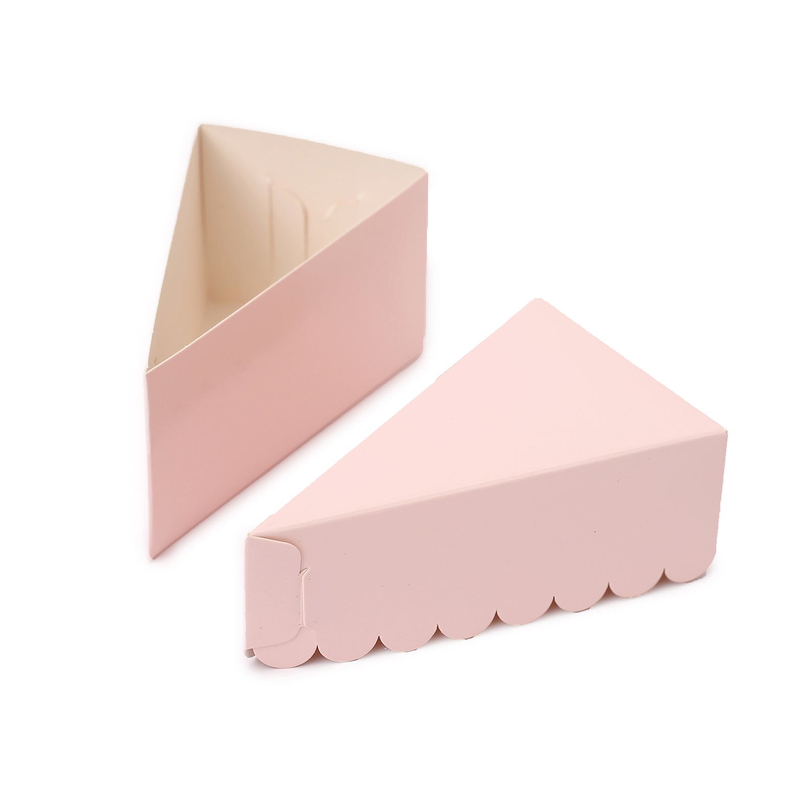 Blush triangular paper cake slice boxes with scalloped tops.