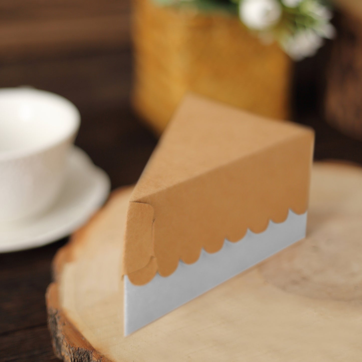 Natural brown paper cake box with white base, triangular shape for desserts.