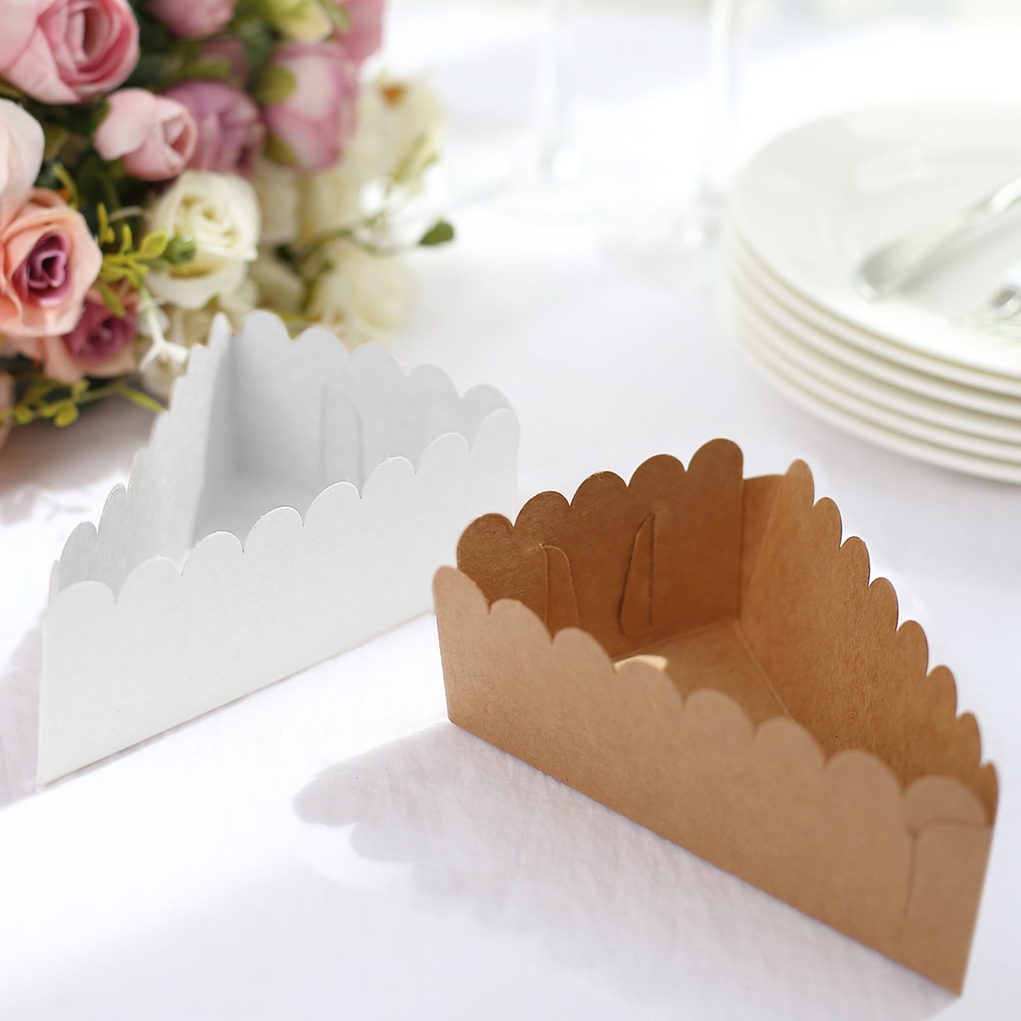 Natural brown paper cake box with white base, triangular shape, scalloped top.