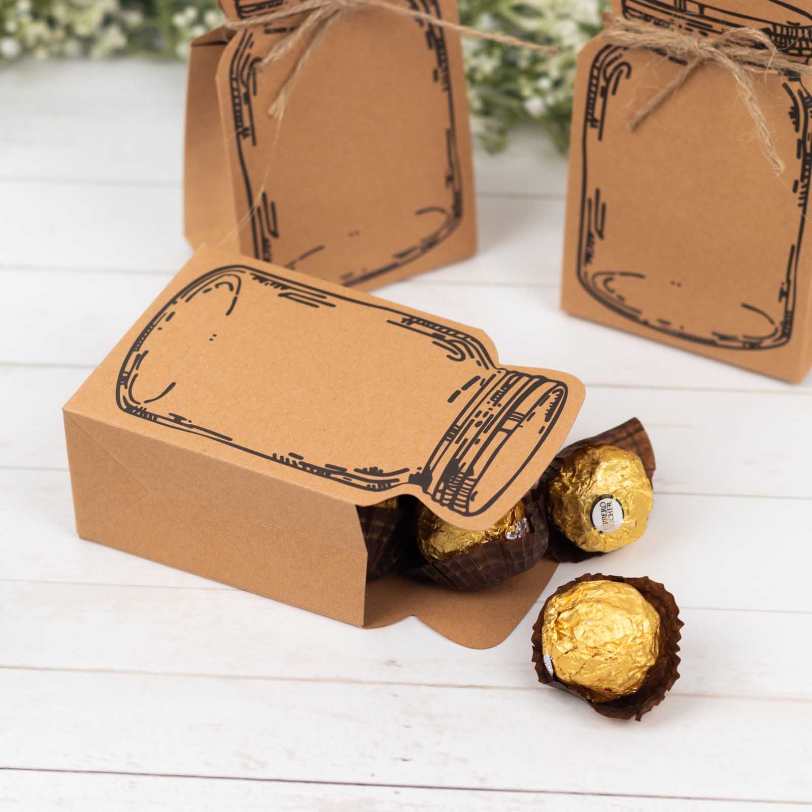 Natural mini mason jar shaped paper favor boxes with jute rope ties.