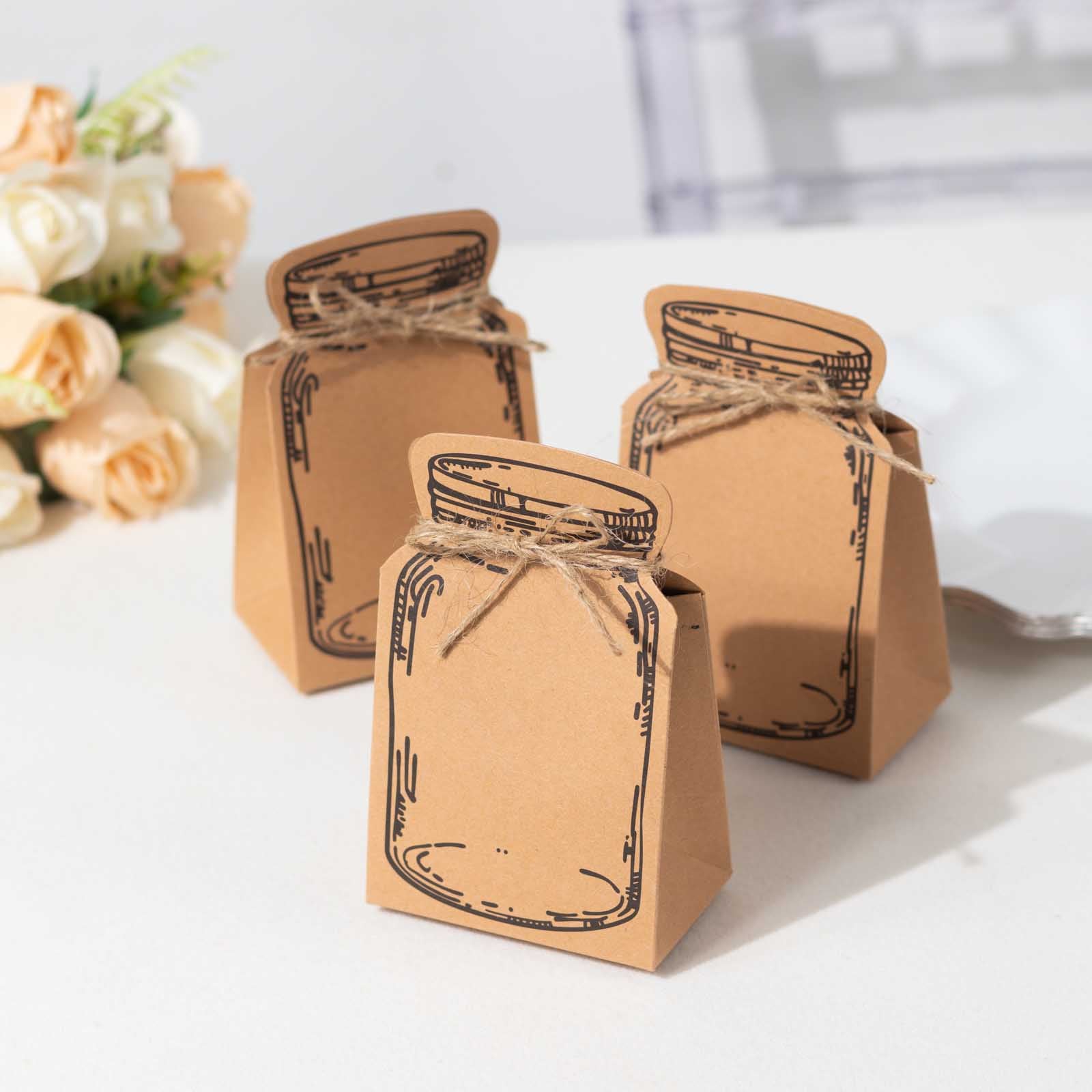 Natural brown mason jar shaped favor boxes with jute rope ties.