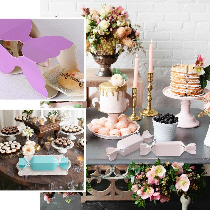 White candy-shaped gift boxes with satin ribbons for party favors.