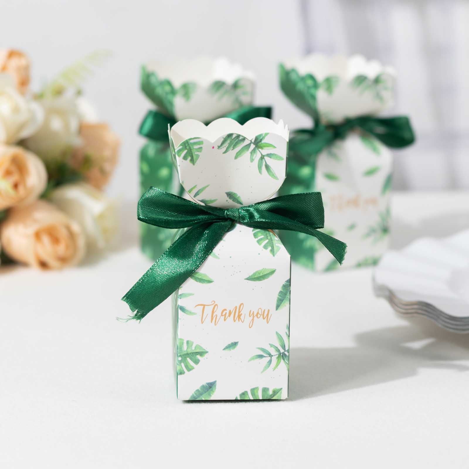 White and green leaf print satin ribbon candy gift box with floral top.