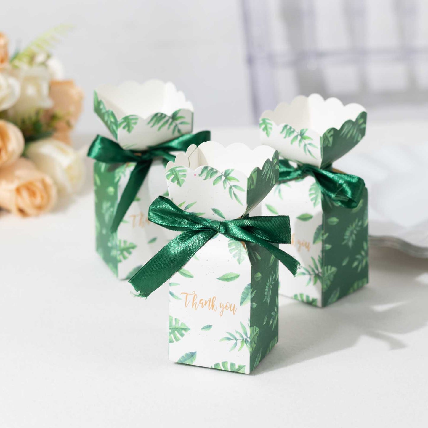 White green leaf print satin ribbon gift boxes with floral tops.