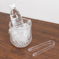 Clear plastic ice bucket with handle and tongs, filled with ice and a water bottle.