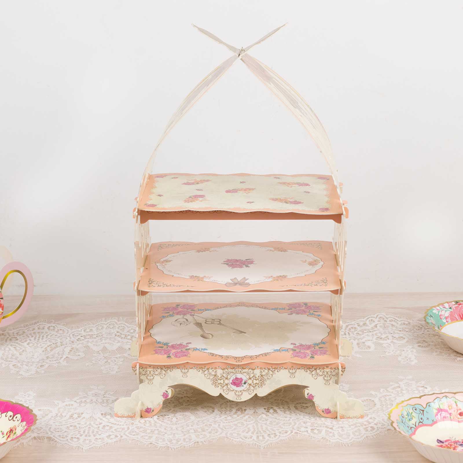 Peach birdcage cardboard dessert display stand with floral print.