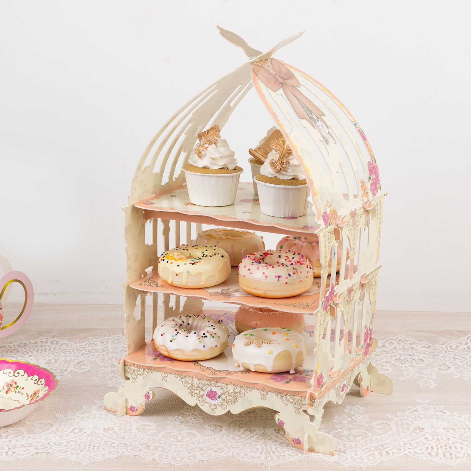 3 Tier white dessert display stand with floral print, holding cupcakes and donuts.