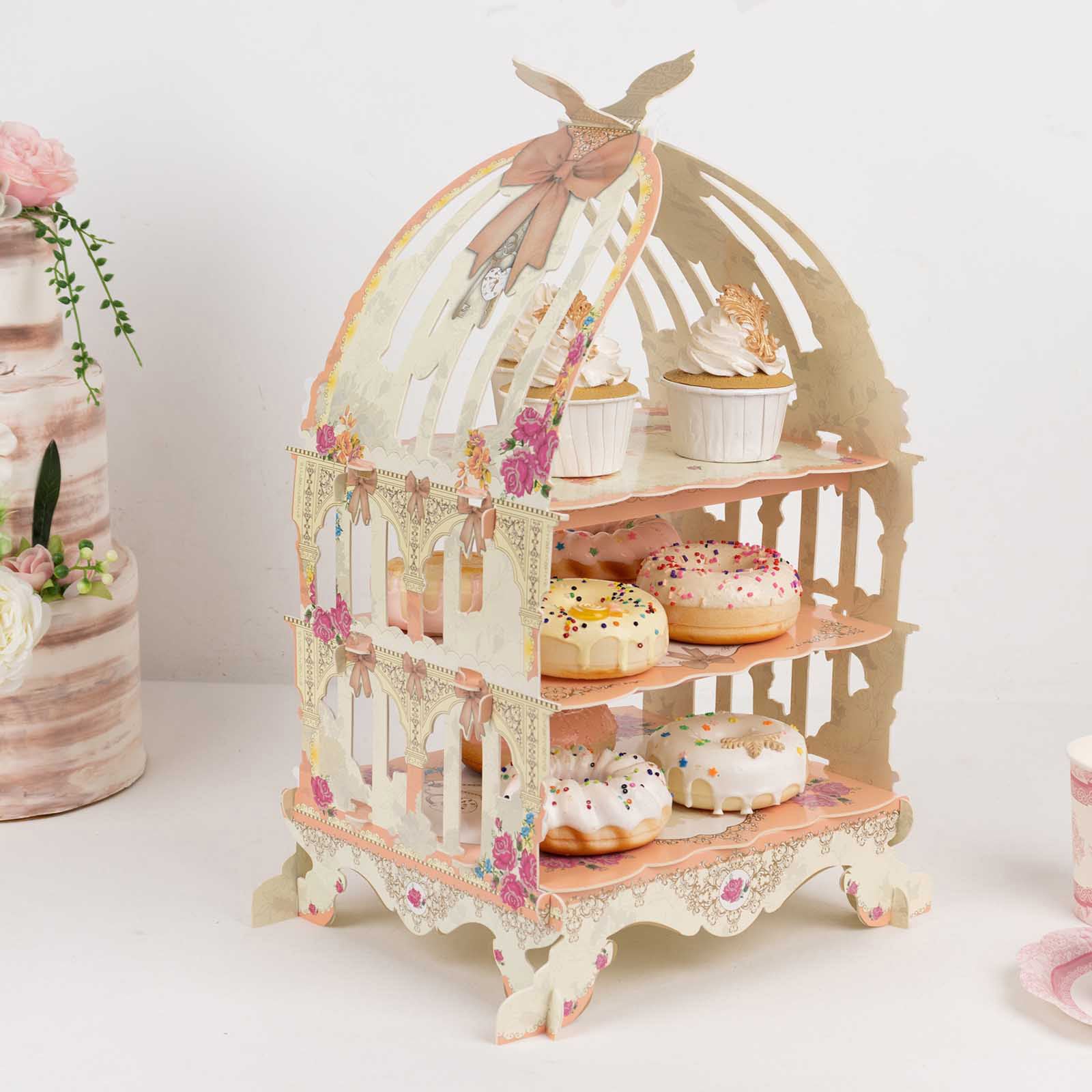 3 Tier white birdcage dessert display stand with floral print and cupcakes.