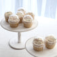 Clear disposable dome lids for baking cake cups with cupcakes.