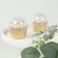 Clear disposable dome lids for 3" cupcake liners on a white plate.
