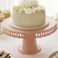 Blush round footed reusable plastic pedestal cake stand with scalloped edges.
