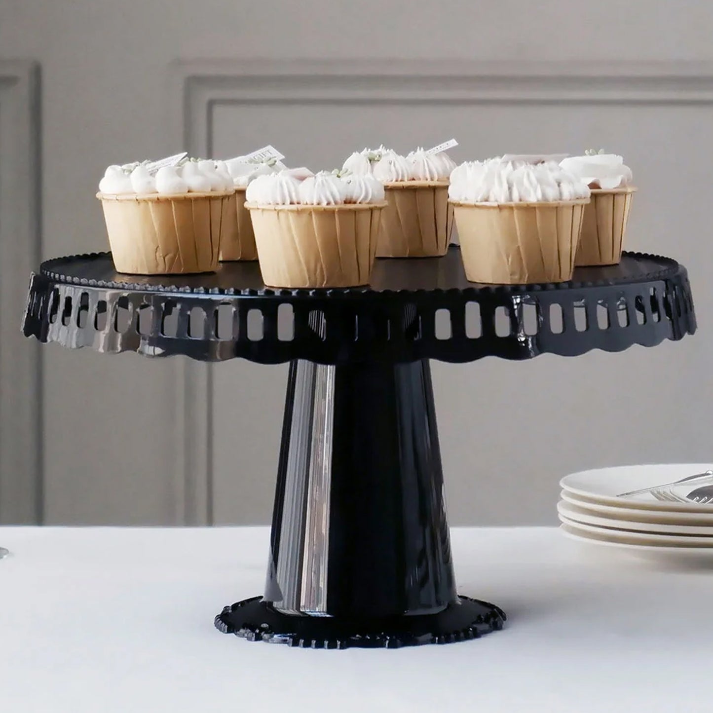 Black round pedestal cupcake stand with interchangeable ribbon trim, perfect for displays.