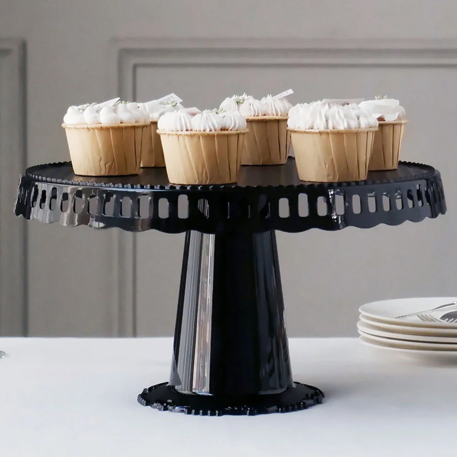Black round pedestal cupcake stand with interchangeable ribbon trim, perfect for displays.