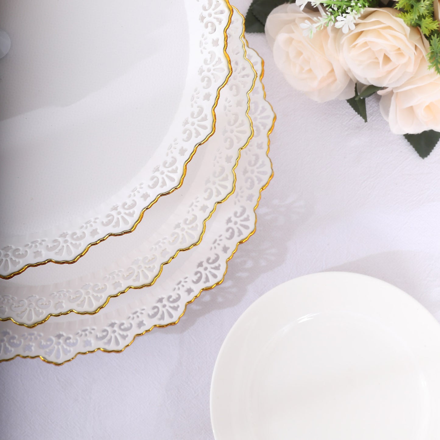 White 3-tier cupcake stand with lace cut gold rim and scalloped edges.