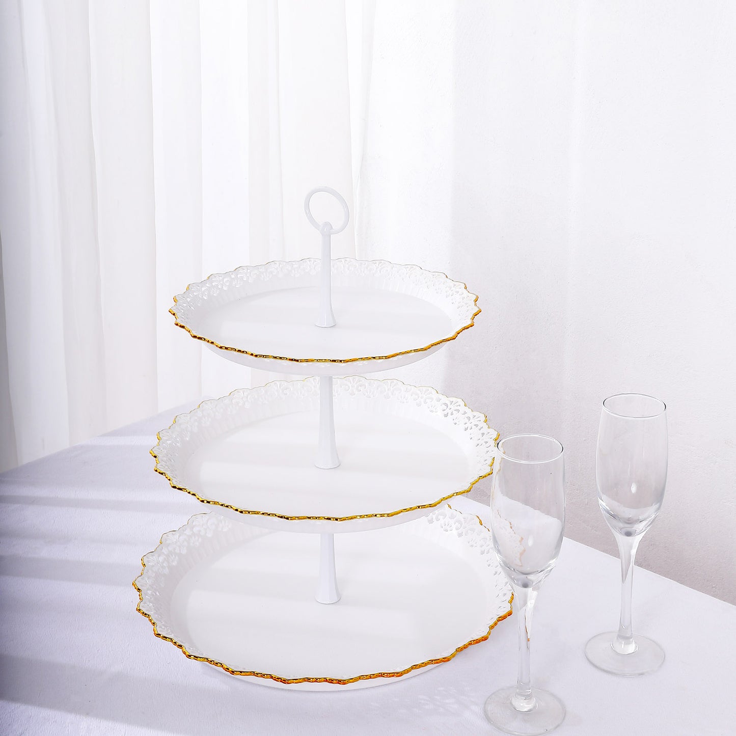 White 3-tier cupcake stand with gold rim and scalloped edges.