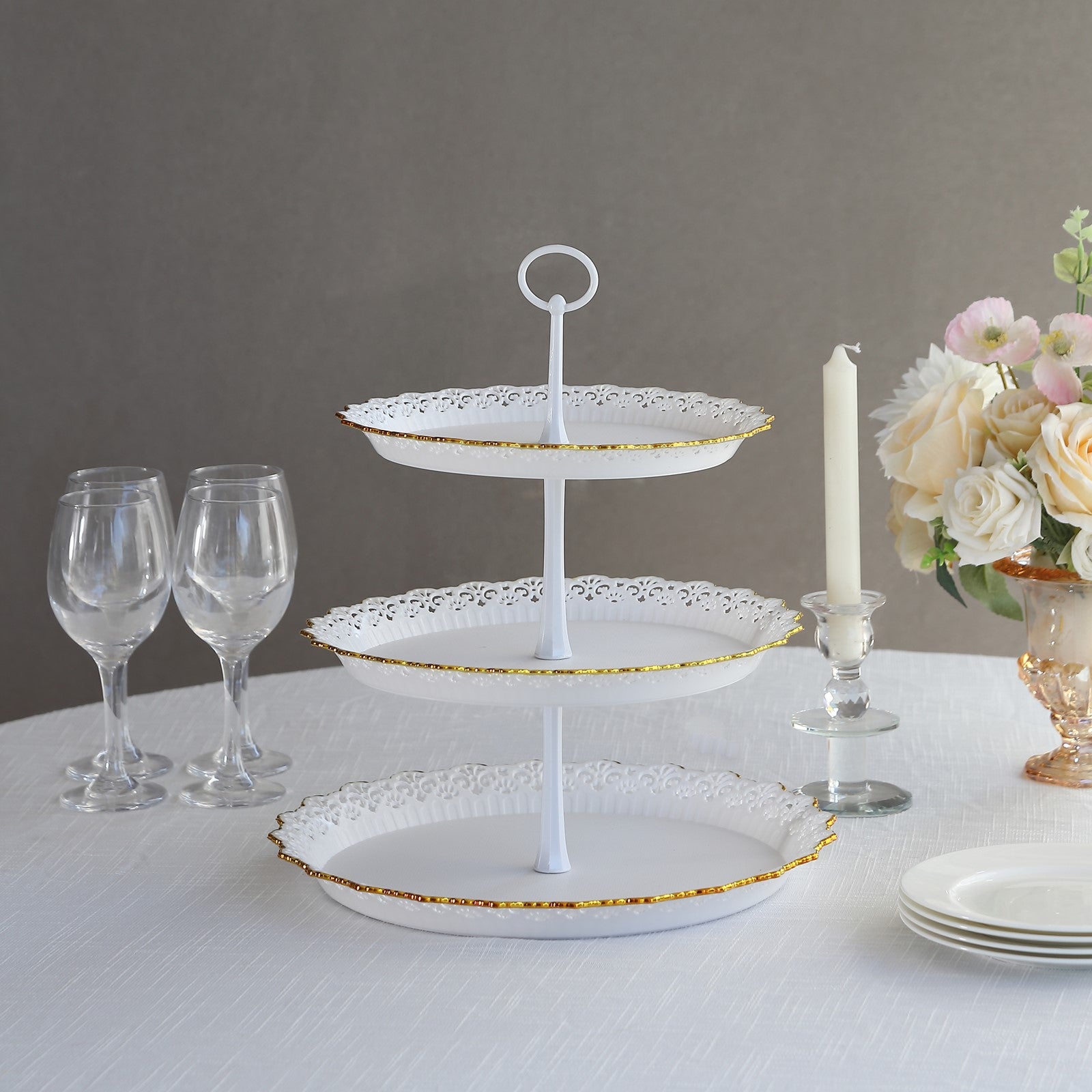 White 3-tier cupcake stand with lace cut gold rim and scalloped edges.