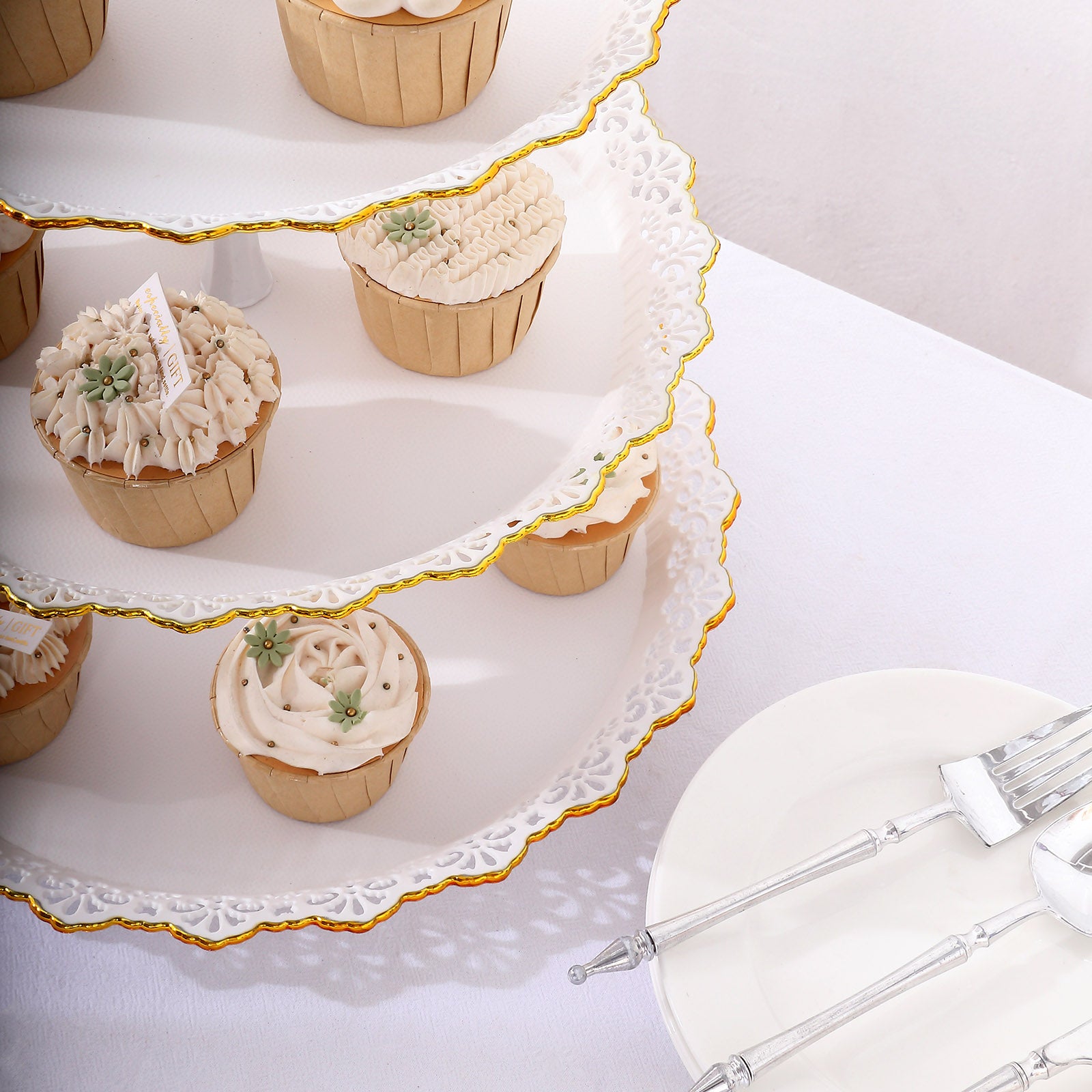White 3-tier cupcake stand with gold rim and scalloped edges.