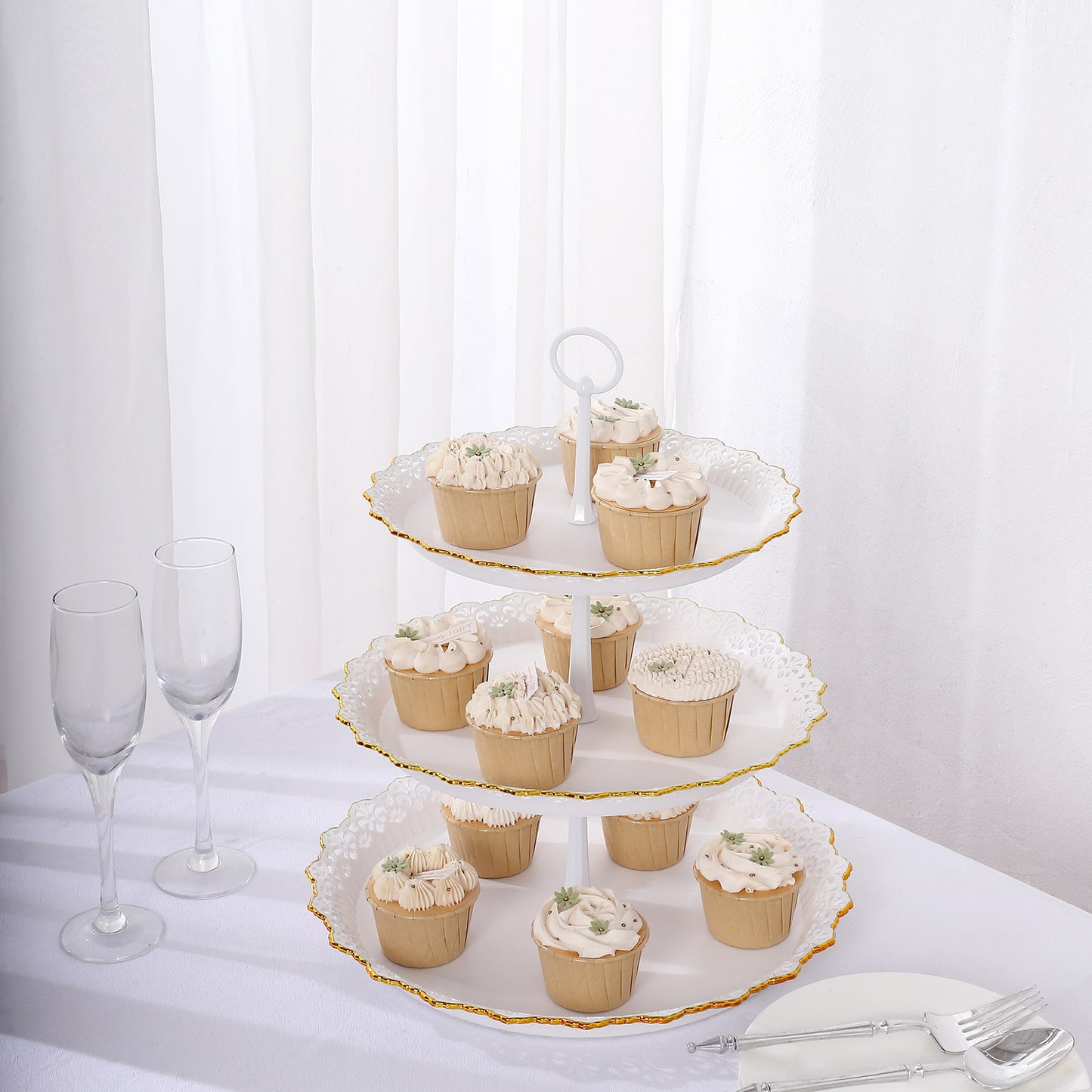 15" white 3-tier cupcake stand with gold rim, displaying decorated cupcakes.