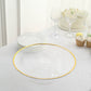 Clear cupcake display riser with gold rim on a table setting.
