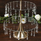 Gold 3-tier acrylic and metal cupcake stand with hanging crystals.