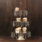 Gold 3-tier cupcake stand with hanging crystals displaying desserts.