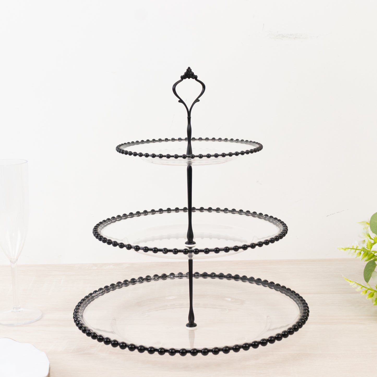 Black 3-tier dessert display stand with beaded rim and top handle.