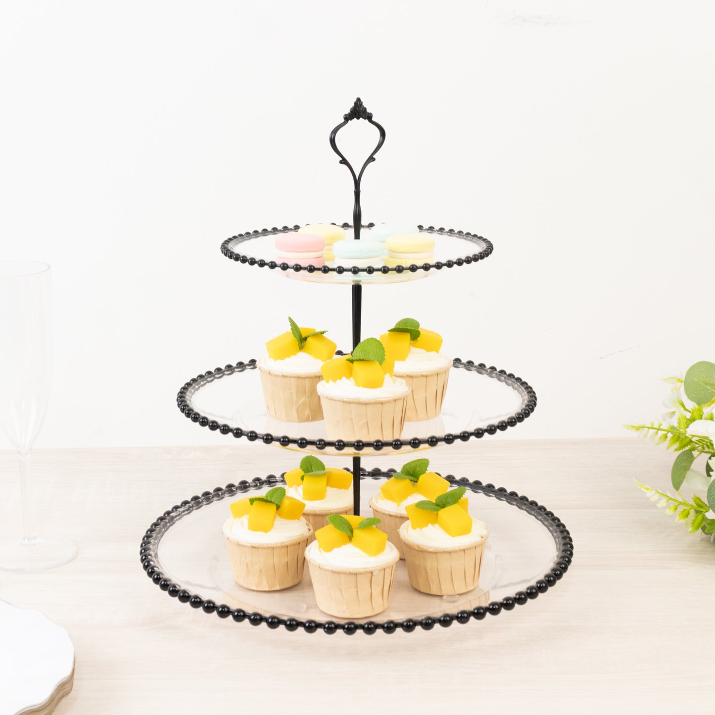 14" clear 3-tier dessert display stand with black beaded rim, featuring cupcakes.